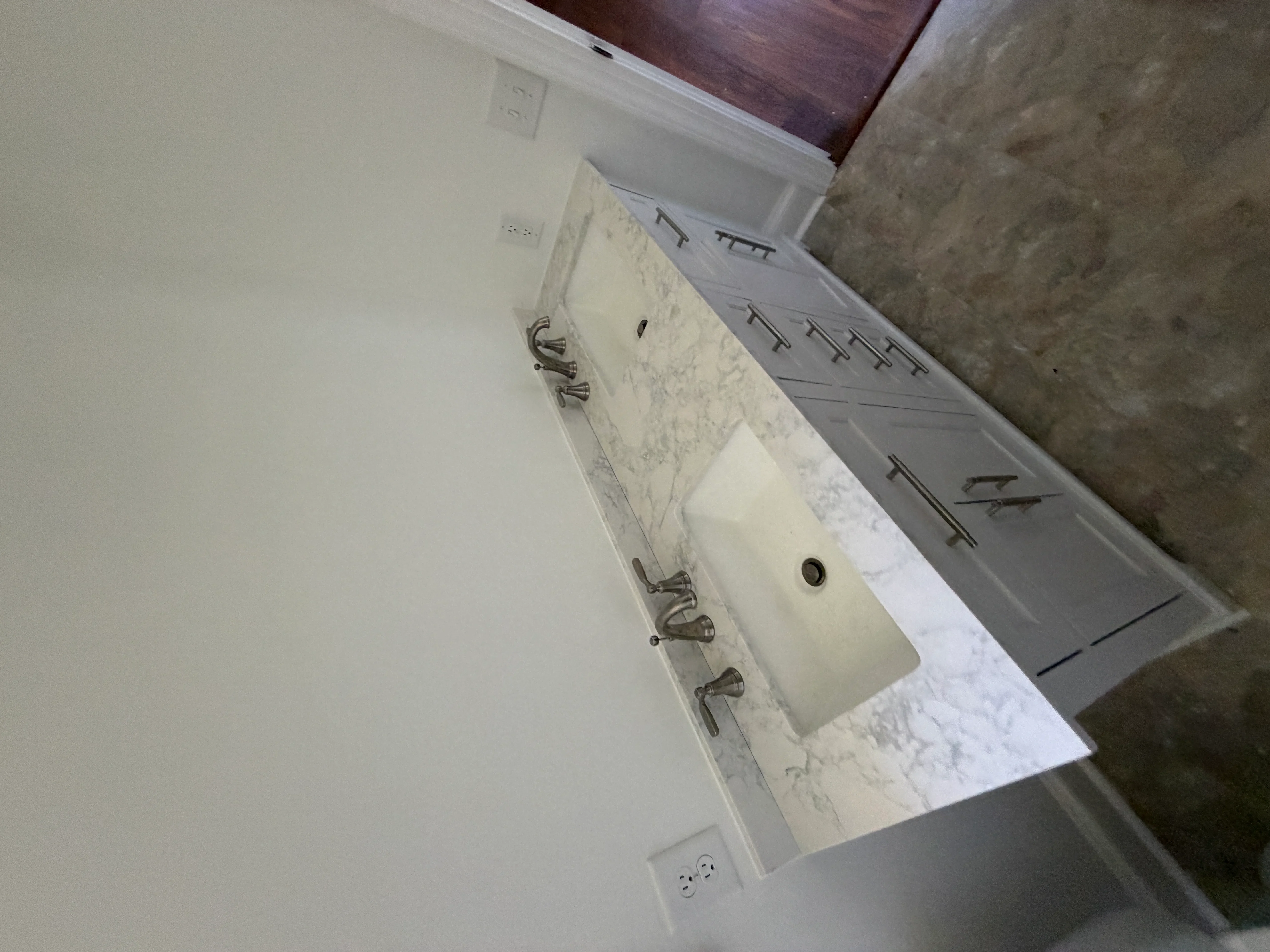 Marble vanity with vessel sink, chrome faucet, and plumbing installation